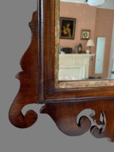mirror with decorative frame bottom left