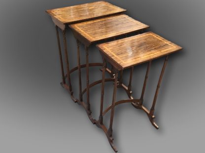 A fine George III Nest of three Tables in Kingwood with Satinwood crossbanding, on elegant turned legs supported by bow stretchers and standing on scrolled feet of unusual design Open