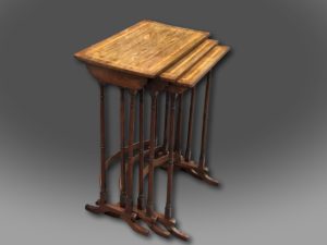 A fine George III Nest of three Tables in Kingwood with Satinwood crossbanding, on elegant turned legs supported by bow stretchers and standing on scrolled feet of unusual design.